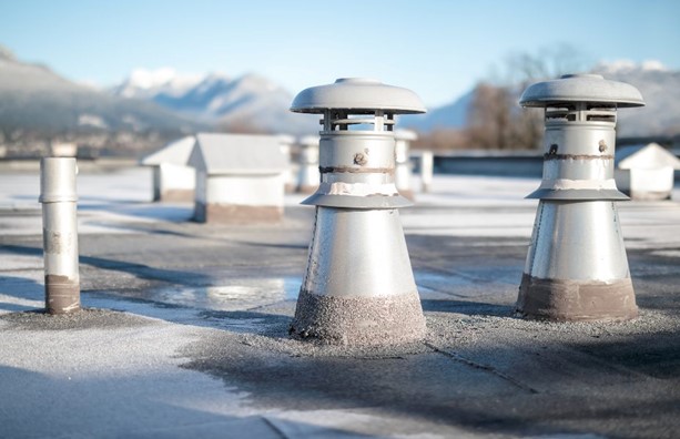 A group of metal pipes on a roof