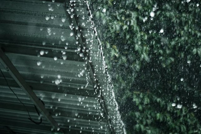 Rain drops of water falling from a roof