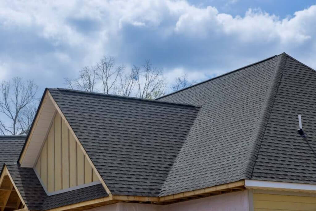 A house in South Florida featuring a shingled roof against a clear sky.